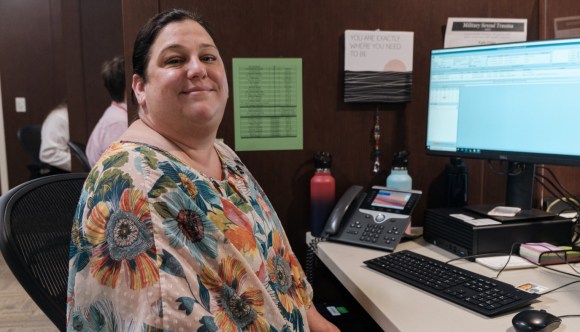 A VA medical support assistant at her desk.