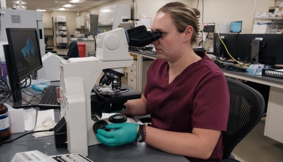 A VA employee working on a medical innovation in a lab.