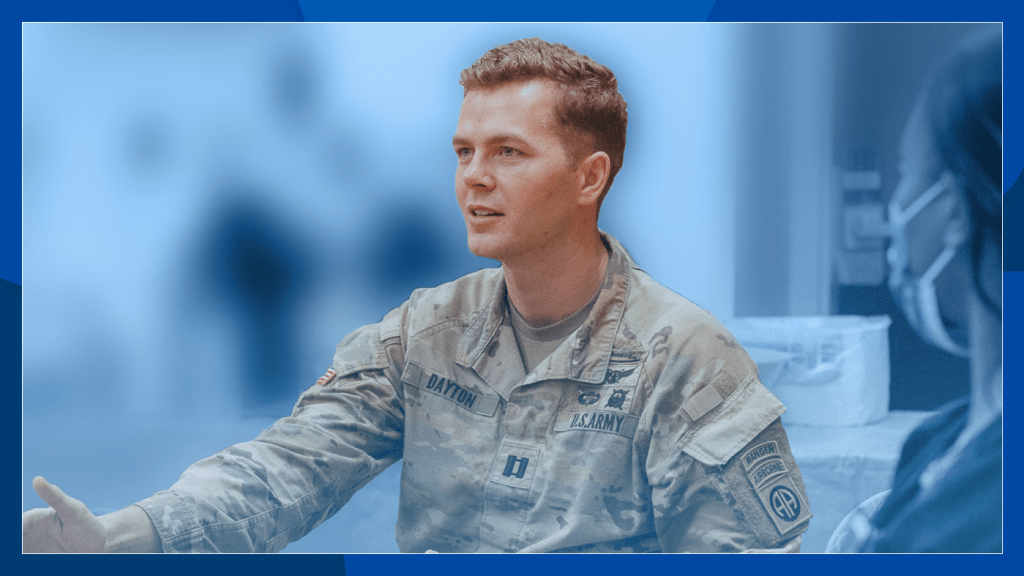 Seated man in Army uniform engages in a discussion.