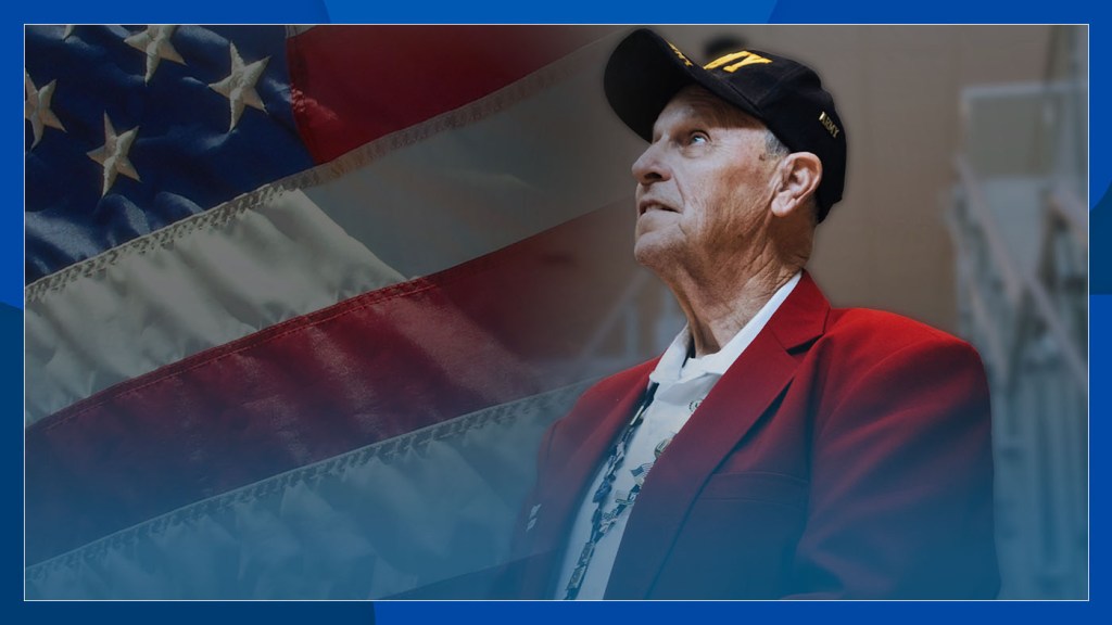 A Veteran stands before an American flag overlay.