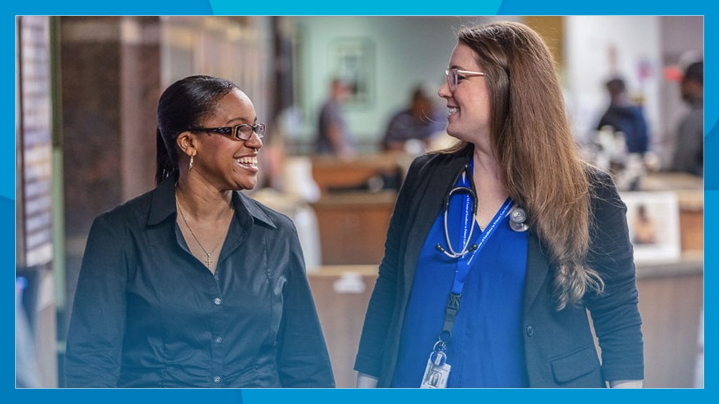 Two VA employees smile at work.
