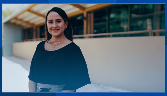 A smiling woman awaits an interview.