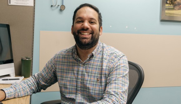 A smiling male VA employee.