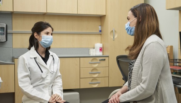 A female VA doctor discusses breast cancer concerns with a female Veteran.