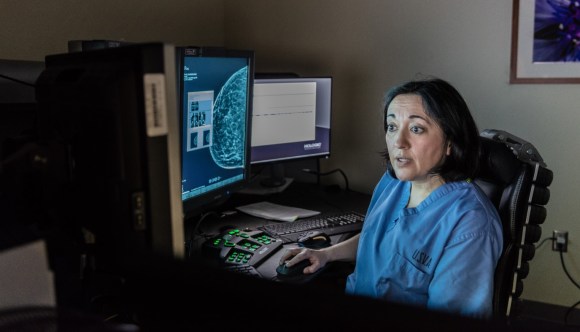 A VA employee examines the results of a mammogram, searching for signs of breast cancer in a Veteran patient.