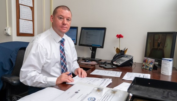 Sitting at a desk, a member of our VA hiring team reviews a cover letter provided by an applicant.