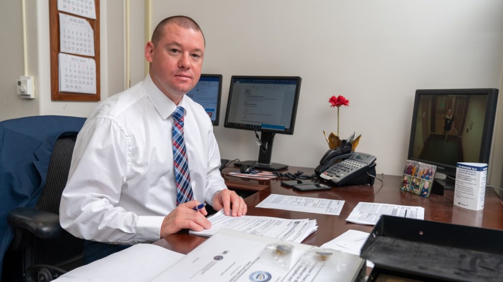 Sitting at a desk, a member of our VA hiring team reviews a cover letter provided by an applicant.