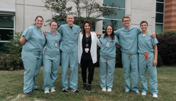 A group of happy VA employees, with arms linked, showcasing our positive workplace culture.