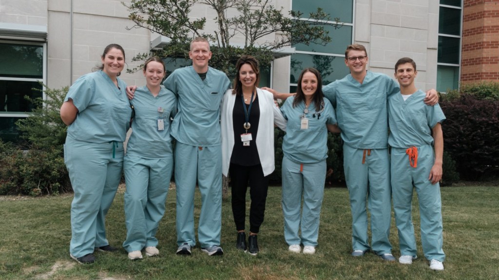 A group of happy VA employees, with arms linked, showcasing our positive workplace culture.