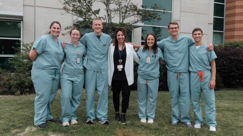 A group of happy VA employees, with arms linked, showcasing our positive workplace culture. 