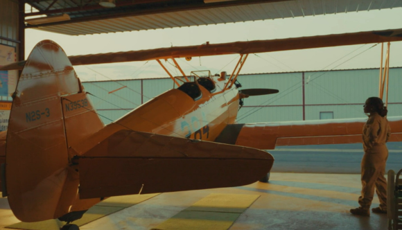 A screenshot from the new VA Careers PSA, showing a female Veteran boarding a biplane.