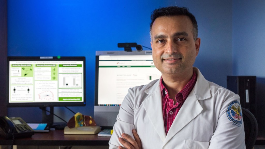 A VA physician standing in front of computer screens, demonstrating our embrace of technology and innovation.