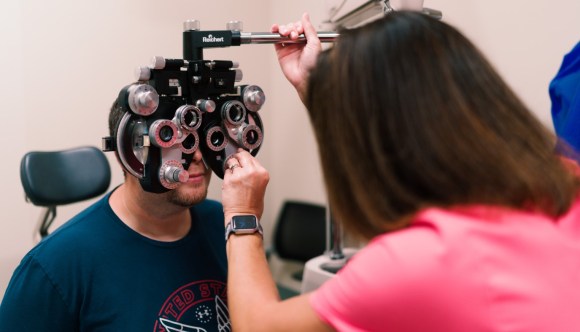 A VA ophthalmologist conducts an exam on a Veteran patient.