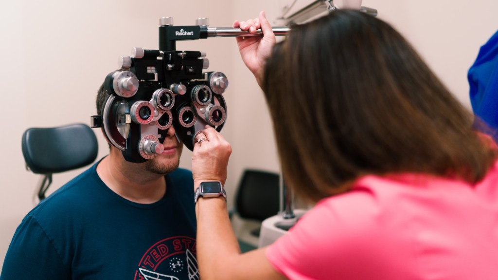 A VA ophthalmologist conducts an exam on a Veteran patient.