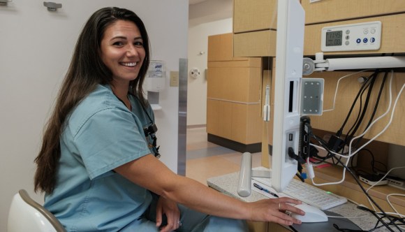 A VA employee working at a computer.